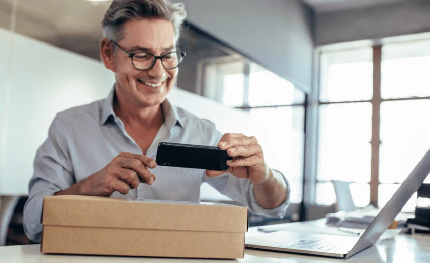 Man taking a photo of water marks